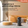 A black oil-filled radiator is placed in a modern living room setting with a yellow sofa and ottoman. Produktbild-Vorschau