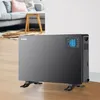 A black Noveen CH7100 LCD Smart Konvektorheizung is placed on a wooden floor in a living room setting, with a sofa and coffee table visible in the background. Podgląd zdjęcia produktu
