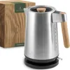 A stainless steel electric kettle with wood accents and its packaging are displayed against a white background. Produktbild-Vorschau