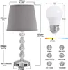 A table lamp with dimensions and features illustrated, alongside a light bulb and icons representing its specifications. Produktbild-Vorschau