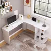 A white L-shaped desk with a computer, lamp, and shelves, positioned near a window. Produktbild-Vorschau