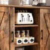 A close-up view of a rustic wooden cabinet with sliding doors, revealing shelves stocked with kitchen items like a toaster, jars, and storage containers. Náhľad obrázku produktu