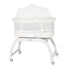 A white baby bassinet with a mosquito net on a white stand with wheels, photographed against a white background. Anteprima dell’immagine prodotto