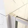 A close-up view of a shower enclosure corner, showing the marble-patterned wall and the metal frame of the shower door. Produktbild-Vorschau