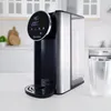 A hot water dispenser with a digital display and a glass of water next to it, set in a clean kitchen environment. Produktbild-Vorschau