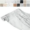 A collage of different textured surfaces above a roll of marble-patterned adhesive film. Produktbild-Vorschau