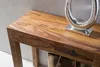 A close-up shot of a wooden console table with a drawer and a decorative silver object on top. Produktbild-Vorschau