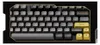 A top-down view of a black and gold mechanical keyboard with yellow accent keys. Produktbild-Vorschau