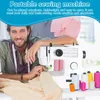 A man is shown using a portable sewing machine, with spools of thread in the foreground. Produktbild-Vorschau