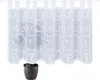 A white sheer curtain with a scroll pattern hangs on a rod, with a potted plant in the foreground. Produktbild-Vorschau
