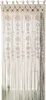 A macrame curtain hanging in a doorway or window. Produktbild-Vorschau