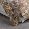 A close-up view of a bedding set with a floral leaf pattern. Produktbild-Vorschau