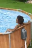 A woman relaxes in an oval above-ground swimming pool. Náhled obrázku produktu