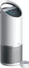 A white air purifier with a silver base and a digital display on top, shown with a small silver accessory next to it. Produktbild-Vorschau