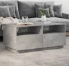 A concrete-effect coffee table in front of a gray sofa. Náhled obrázku produktu