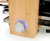 Close-up of a raclette grill's control knob with a blue LED light ring. Produktbild-Vorschau