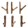 Six wooden hooks made from teak root, arranged in two rows of three against a white background. Náhled obrázku produktu