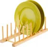 A wooden plate rack holding two green plates. Produktbild-Vorschau