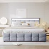 A bedroom scene with a bed as the main focus, featuring a vanity and a framed picture on the wall. Voir les images du produit