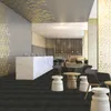 A modern interior with a marble reception desk, seating area, and decorative ceiling and wall elements. Náhled obrázku produktu