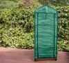 A green greenhouse on a wooden deck, with a hedge in the background. Anteprima dell’immagine prodotto