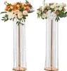 Two tall, gold-colored flower stands adorned with crystal beads and topped with floral arrangements. Podgląd zdjęcia produktu