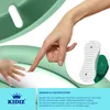 A hand is pointing to a soft surface on a green children's toilet seat. Produktbild-Vorschau