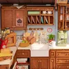 A miniature kitchen scene with cabinets, sink, coffee maker, and various kitchenware. Náhľad obrázku produktu