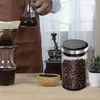 A person is preparing coffee using a pour-over method, with a vacuum-sealed coffee bean container prominently displayed. Náhled obrázku produktu