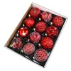 A box of red Christmas ornaments. Produktbild-Vorschau