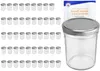 A collection of small glass jars with silver lids, alongside a single larger jar and a booklet. Produktbild-Vorschau