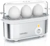 A white and silver electric egg boiler with a clear lid containing three white eggs. Podgląd zdjęcia produktu