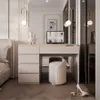 A modern bedroom with a vanity desk, stool, and bed. Produktbild-Vorschau