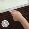 A hand is shown adjusting a window blind mechanism. Produktbild-Vorschau