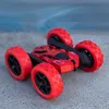 A red remote-controlled car with black accents and red wheels is shown on a gray surface with a blurred blue background. Produktbild-Vorschau