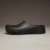 A black Birkenstock Super Birki 2.0 Polyurethane Clog is shown from the side against a plain gray background. Produktbild-Vorschau