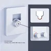 A close-up of a retractable clothesline mounted on a wall, with inset images showing its features. Podgląd zdjęcia produktu