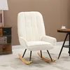 A cream-colored rocking chair is placed next to a multi-drawer cabinet and a small round table with a cup of coffee on it. Produktbild-Vorschau