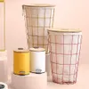 A collection of three laundry baskets and two small trash cans with lids, arranged on pedestals against a light pink background. Podgląd zdjęcia produktu