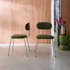 Two chairs with green upholstered seats and backs, one with a curved wooden backrest, are placed in a room with a wood-paneled wall and a reflective surface. Anteprima dell’immagine prodotto