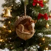 A close-up of a Christmas ornament shaped like an acorn with a baby horse inside, hanging on a decorated Christmas tree with lights and snow. Produktbild-Vorschau