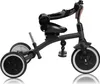 A black and beige tricycle is shown against a white background. Podgląd zdjęcia produktu