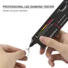 A hand holding a diamond ring while a diamond tester is being used to test the diamond. Produktbild-Vorschau