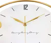 Close-up of a wall clock face with gold hands and black numerals. Produktbild-Vorschau