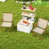 Two camping chairs and a folding shelf unit are set up on a grassy lawn, suggesting an outdoor recreational setting. Produktbild-Vorschau