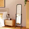 A bedroom scene with a bed, nightstand, and a full-length mirror. Anteprima dell’immagine prodotto