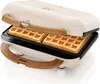 A waffle maker with two waffles inside, shown from a diagonal angle. Produktbild-Vorschau