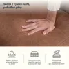 A close-up of a hand pressing into a brown fabric sofa cushion, with illustrative icons below. Náhled obrázku produktu
