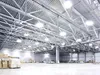 Interior of a large, modern warehouse with high ceilings, exposed metal beams, and bright overhead lighting. Podgląd zdjęcia produktu