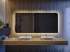 A modern bathroom vanity with two sinks and a large, illuminated mirror. Produktbild-Vorschau